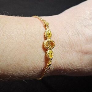 Gold tone adjustable slider bracelet with citrine